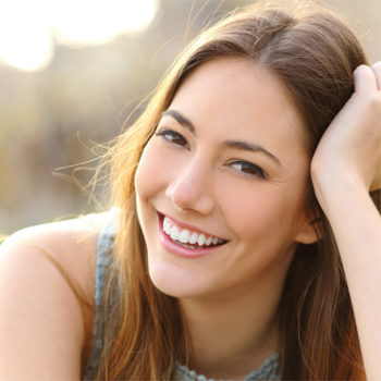 Smiling woman with her hand on her hair