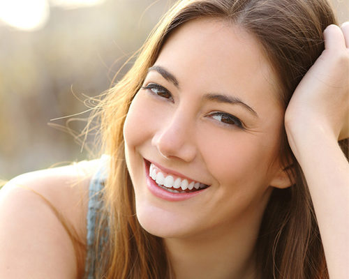 Smiling woman with her hand on her hair