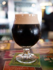 Dark foamy beer in a glass goblet