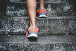 Legs in athletic sneakers ascending stairs