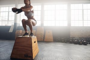 Woman jumping on a block