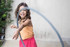 Child playing with a hula hoop