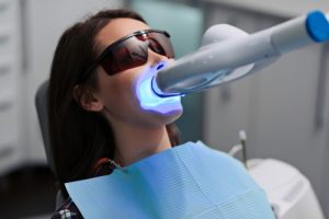 young female patient undergoing professional teeth whitening