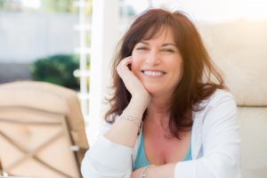 middle-aged woman smiling outdoors